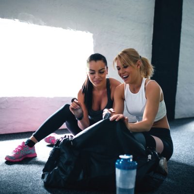 Two friends enjoying time together at the gym.